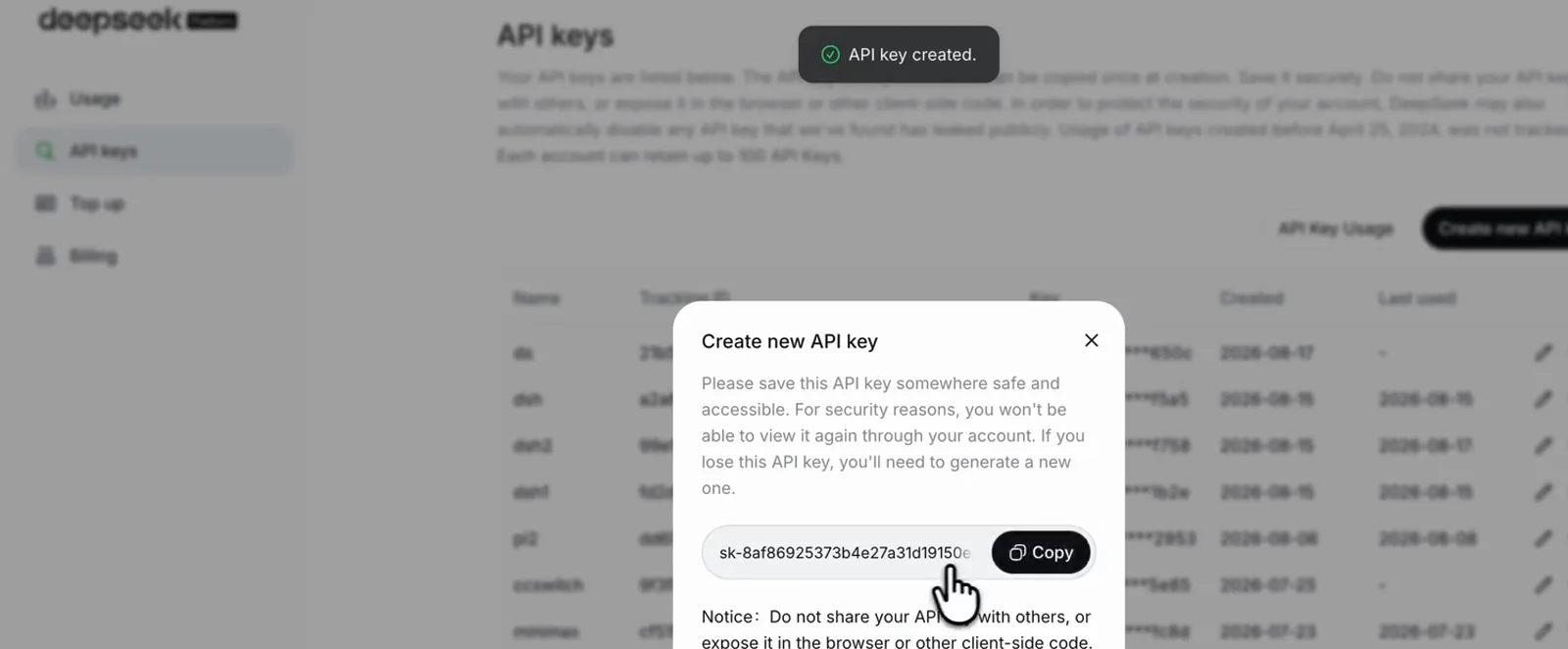 DeepSeek platform API keys page with the Create new API key dialog open and an "API key created" confirmation toast